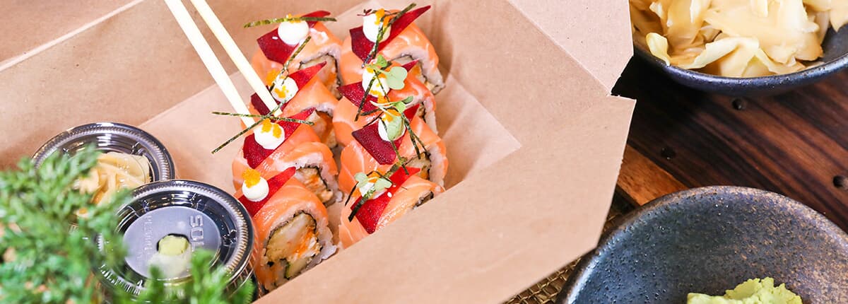 a sushi roll in a take out container