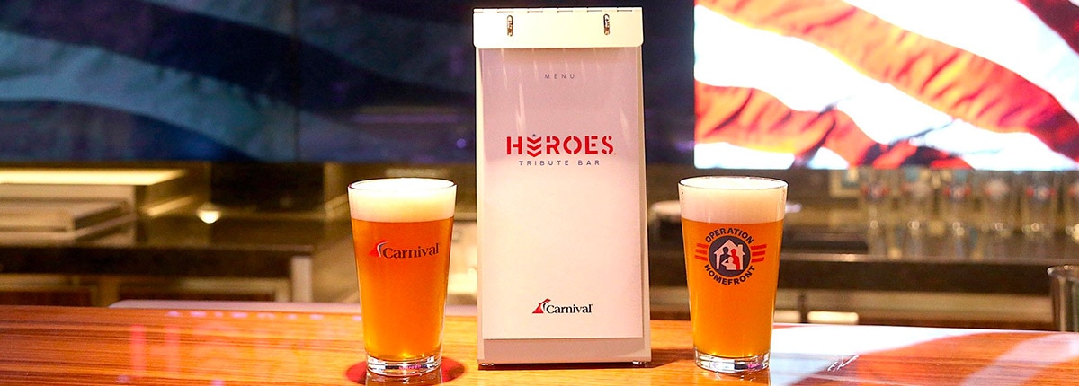 the heroes tribute bar menu and a carnival pint glass and an operation homefront pint glass filled with beer