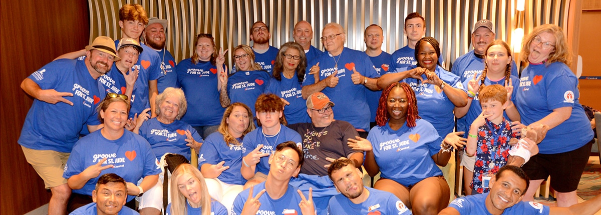 group of people lined up and posing for a photo at a St Jude event