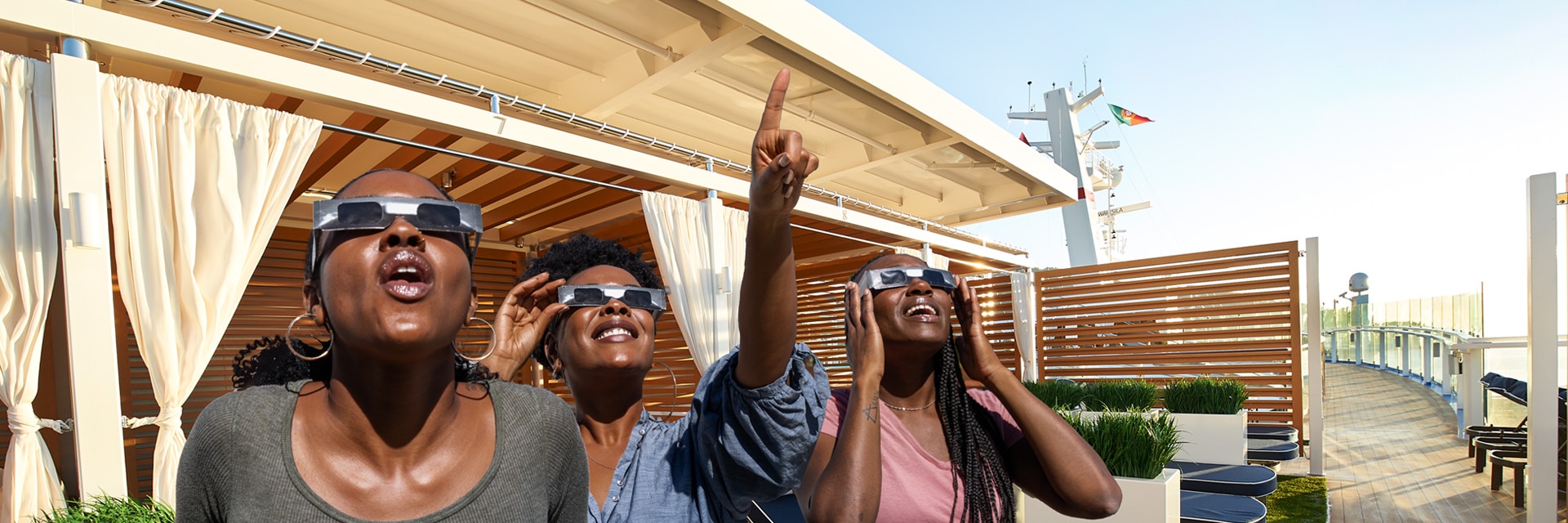 guests with special glasses look up to the sky on a carnival ship