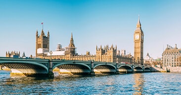 big ben and house of parliament sitting across from the london bridge