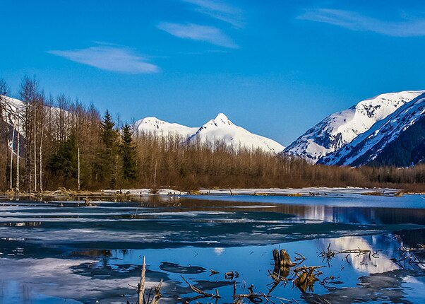 view of the lake and mountains covered in snow