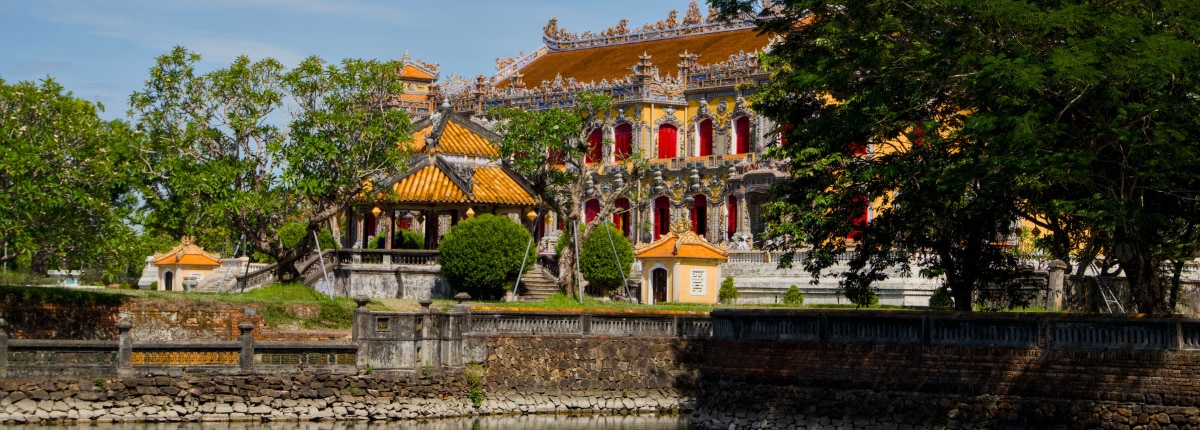 historic palace in vietnam featuring ornate architecture, gardens, and trees