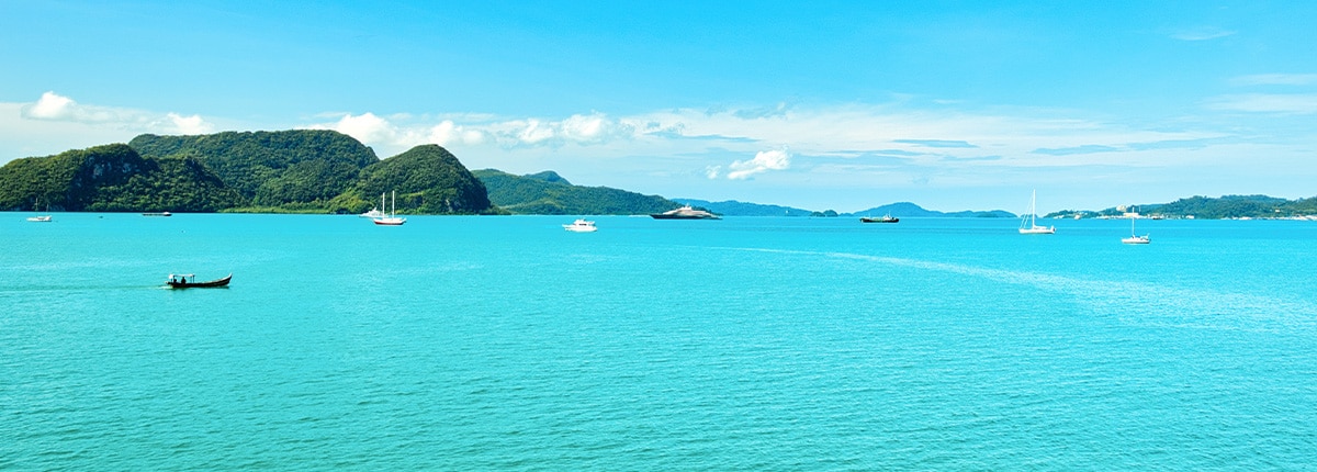 view of the turquoise water and anchored boats in langkawi island