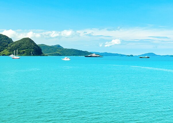 view of the turquoise water and anchored boats in langkawi island