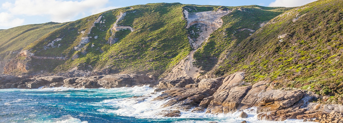 the ocean brushes against a mountain located in albany