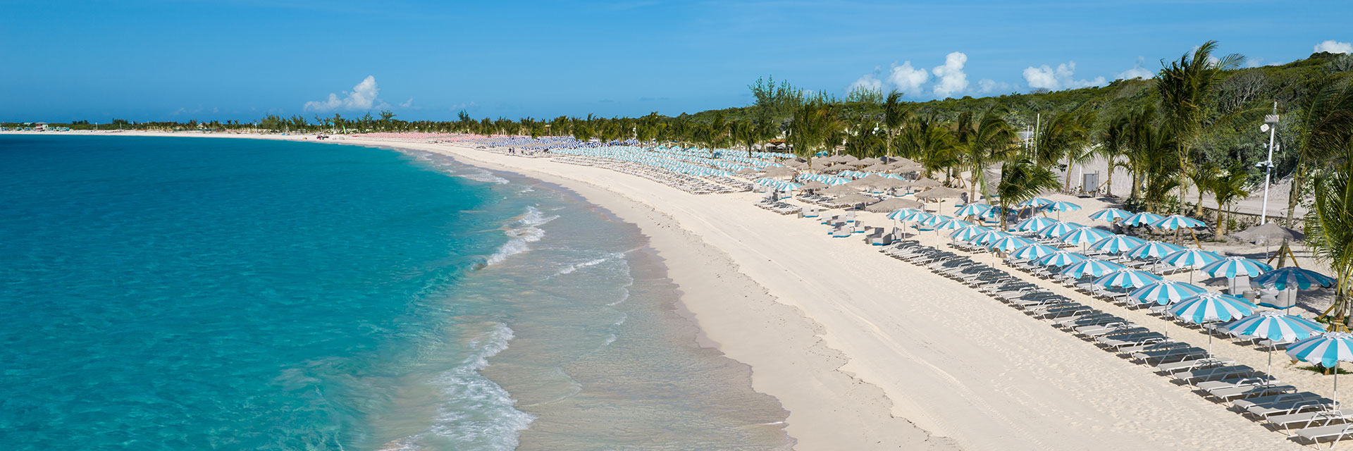 beach at relaxaway, half moon cay with chairs and umbrellas