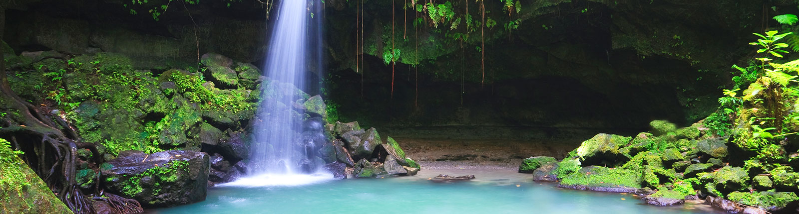Beautiful waterfall and mossy rocks in the hills of Dominica