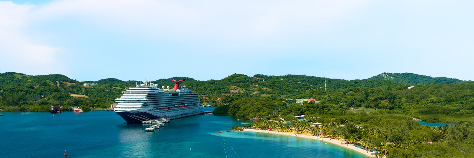 a carnival ship docked at an island