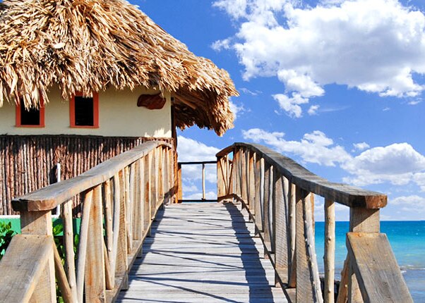 tiki hut in belize overlooking ocean