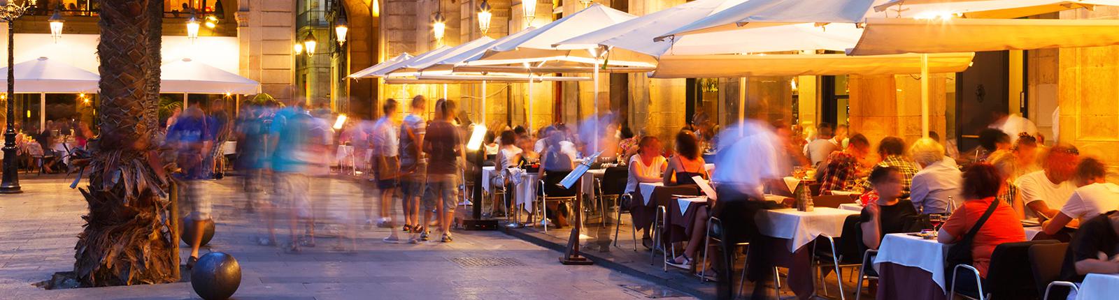 Busy cafes along the street in the Gothic Corner of Barcelona, Spain