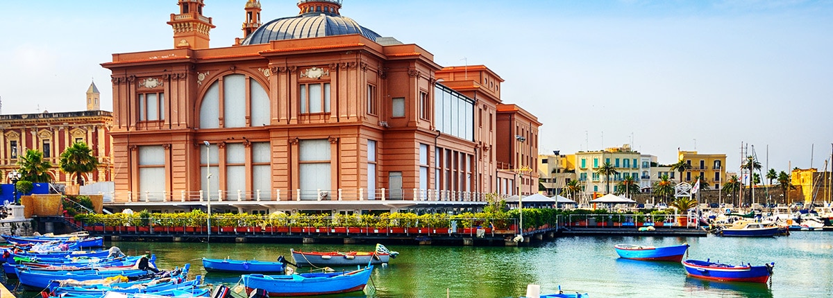 view of several blue kayaks and the beautiful margherita theatre 