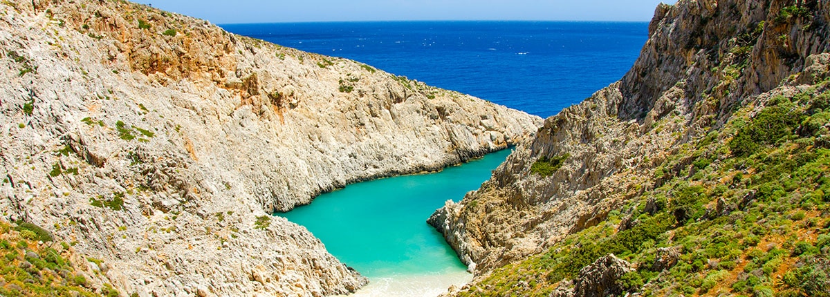 isolated beach surrounded by mountains in chania