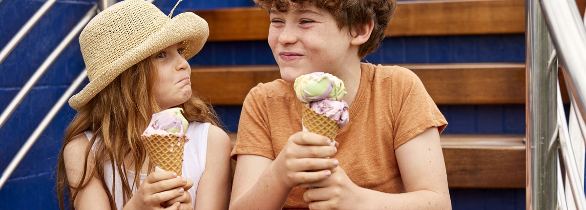 a young girl and boy eats an  ice cream cone