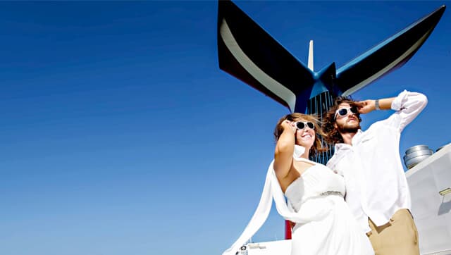a couple posing for a photo after their wedding with the carnival funnel in the back