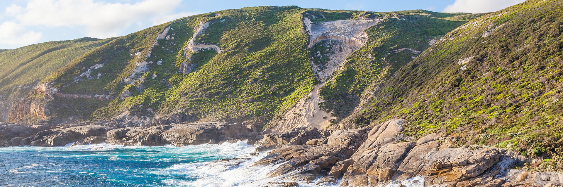 the ocean brushes against a mountain located in albany