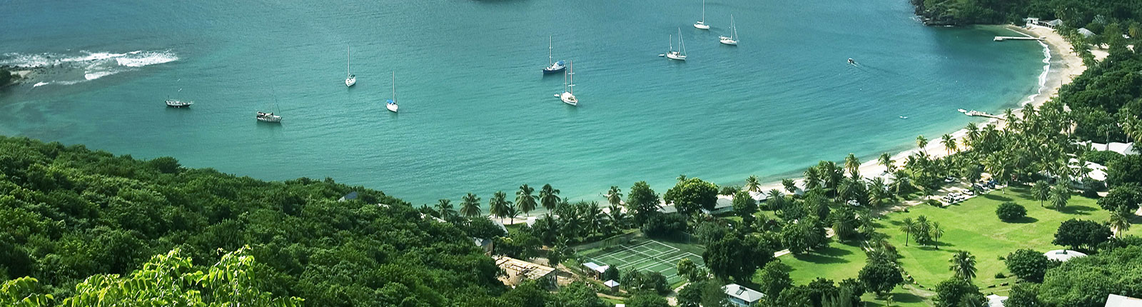 Aerial view of a crescent beach resort in Antigua