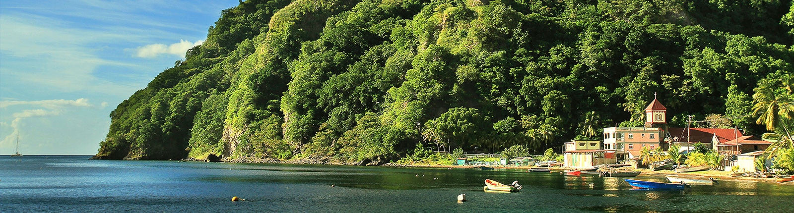 View of the coastal mountains and sea in a fishing village of Dominica