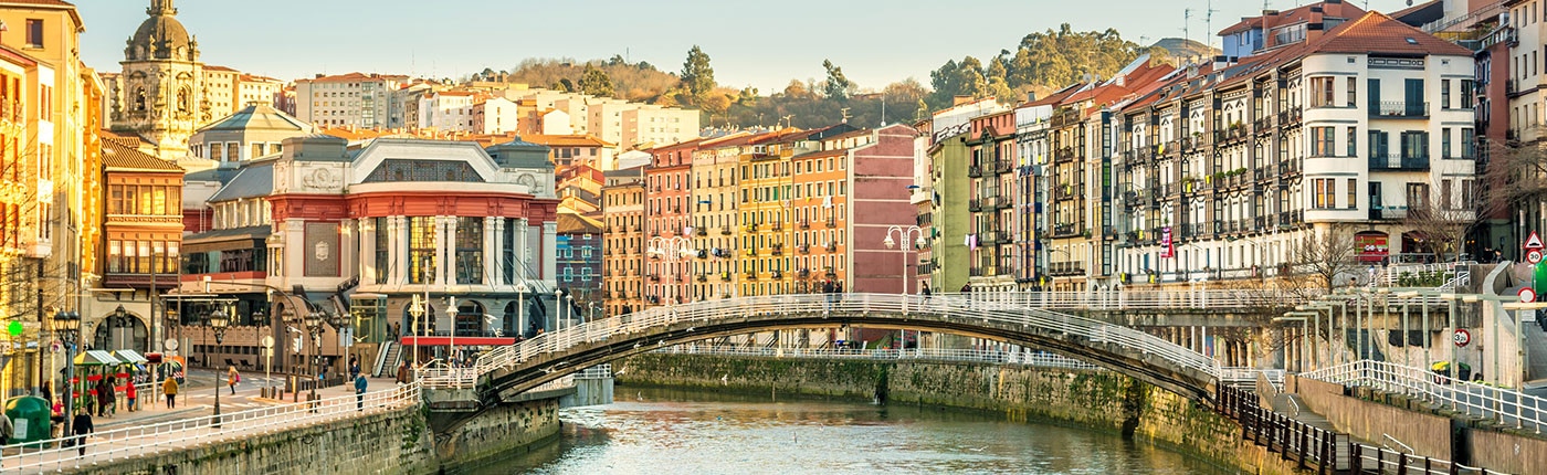 the ria del bilbao surrounded by bright, colorful buildings