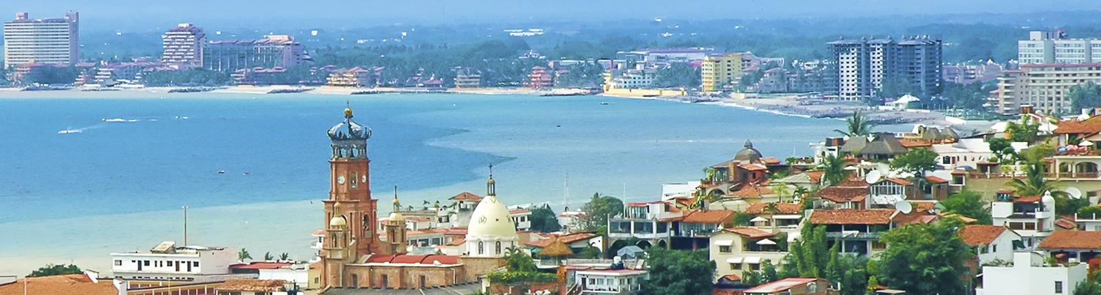 Beautiful historic buildings circling around a pool of rich blue ocean water in Puerto Vallarta, Mexico