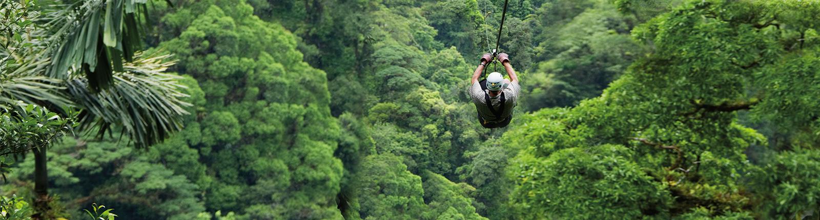 Man ziplining through a beautiful green forrest in Puntarenas, Costa Rica