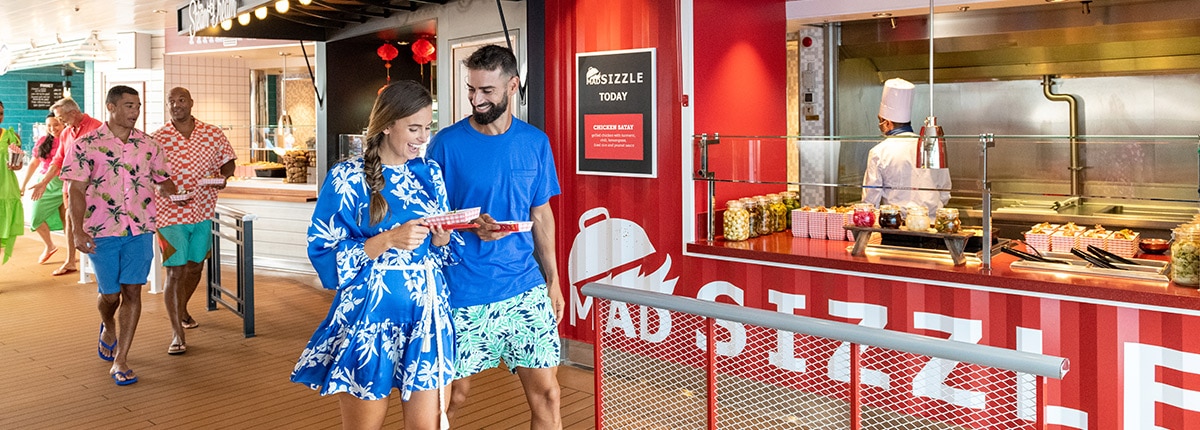 two guests walks away with their meals at street eats
