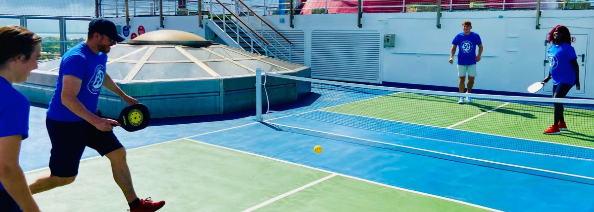 guests playing a fun game of pickleball on a carnival cruise ship
