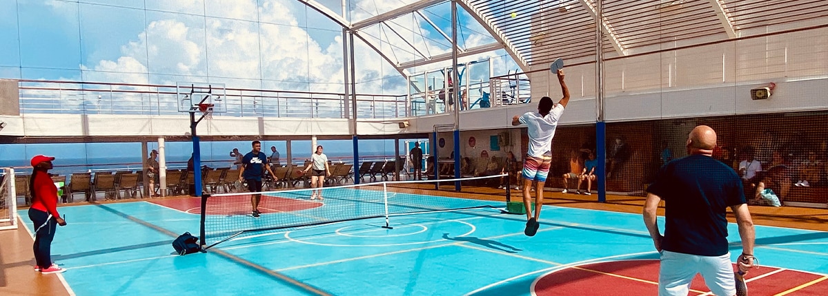 guests playing a game of pickleball on a carnival cruise ship