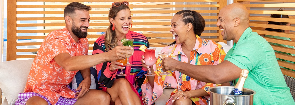 guests enjoying drinks while relaxing under the cabana in the loft 19 area onboard carnival mardi gras