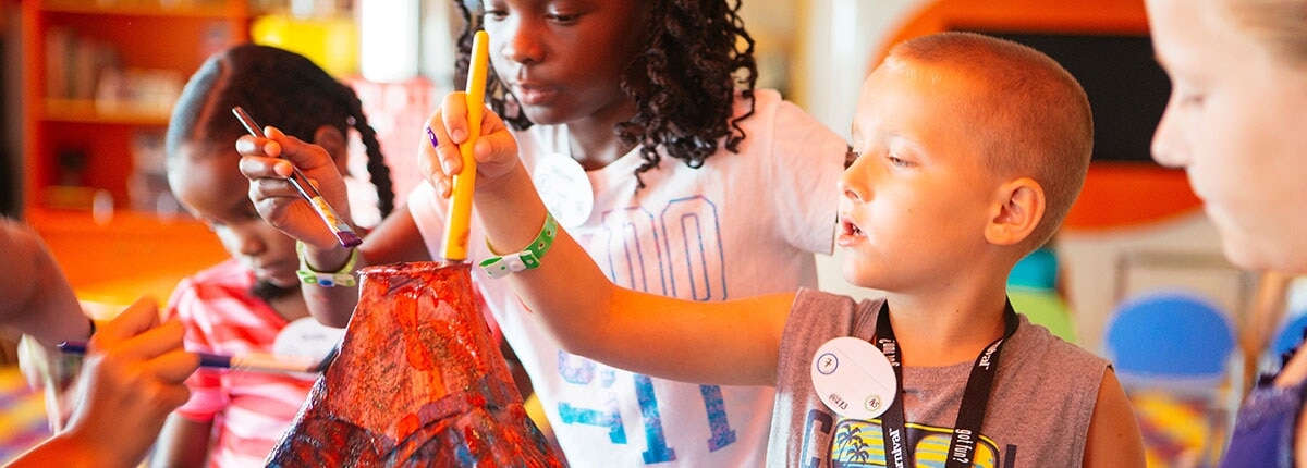 children enjoying arts and crafts aboard a carnival cruise ship