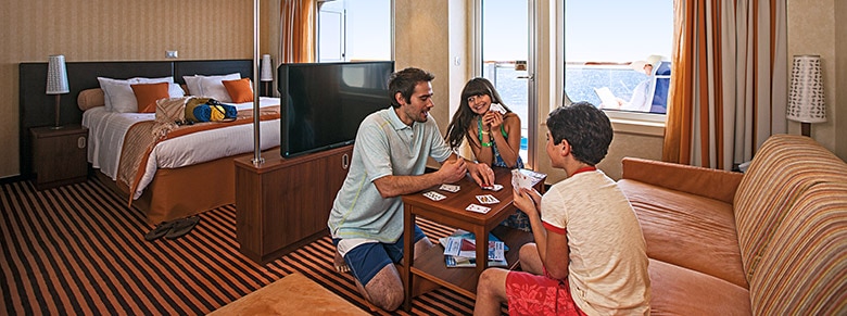 Family playing cards in a Carnival Cruise Line suite